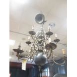 A large heavy brass Dutch style ceiling light with typically shaped branches