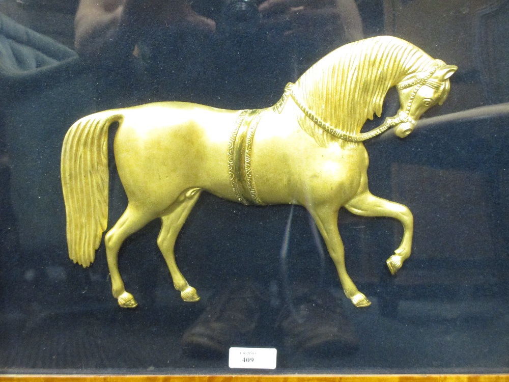 A gilt horse, in a maple frame