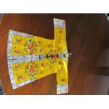 A Chinese lady's silk yellow ground robe embroidered with coloured flowers, the length from collar