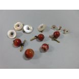 A small collection of gentleman's requisites, including four 1.3cm banded cornelian bead buttons and