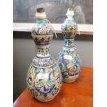 A pair of north African pottery double gourd vases as lamps