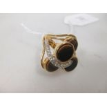 A tigers eye dress ring, the four tigers eye discs, collet mounted with an asymetrical arc of