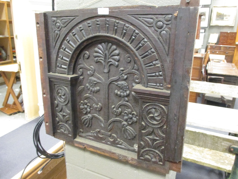 A 17th century and later carved oak panel from a coffer