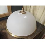 A frosted glass and brass ceiling light