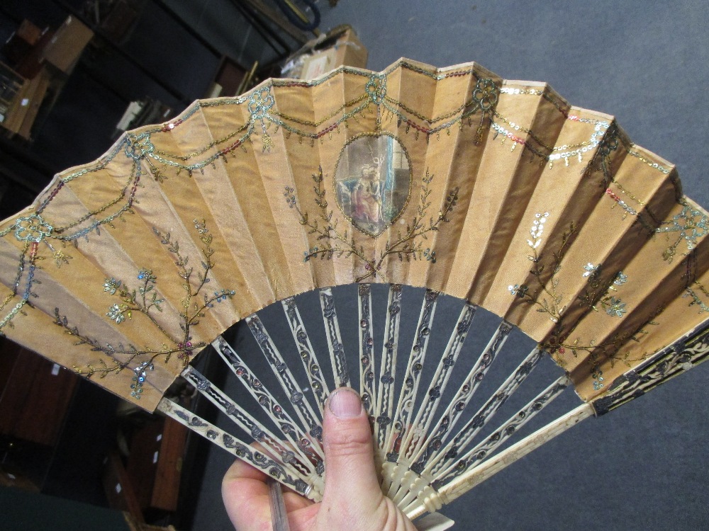 A late 18th century bone and white metal inlaid fan painted with classical scenes and various - Image 3 of 4
