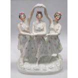 A 19th century Staffordshire group of three dancing ladies, 39cm high Hairline to the base but not