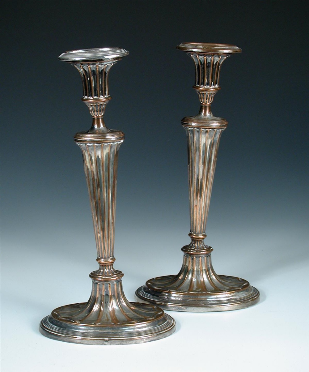 A pair of Old Sheffield plate Adam style candlesticks, with oval fan fluted bases, 31cm high