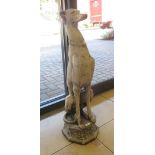 A pair of reconstituted stone figures of whippets, seated on an octagonal plinth base, 79cm high