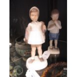 A pair of Bing and Grondahl figures of a girl and boy