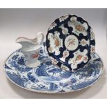 A New Hall cream jug, first period Worcester plate and a Delft blue and white dish The Worcester and