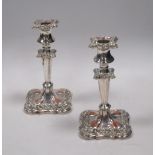 A pair of Old Sheffield Plate wine coasters together with a pair of candlesticks