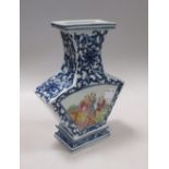A Chinese baluster vase of rectangular section painted in famille rose with fan shaped panels of