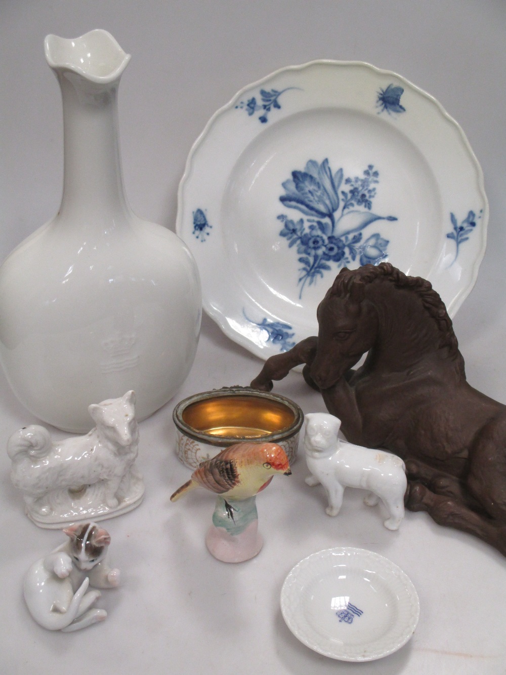 A Bottger 'Steinzug' reclining foal, Meissen blue and white floral plate, Rosenthal cat, two dog