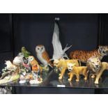 Nine ceramic bird figures or groups by Crown Derby, Beswick, Hutschenreuter and others, one tiger