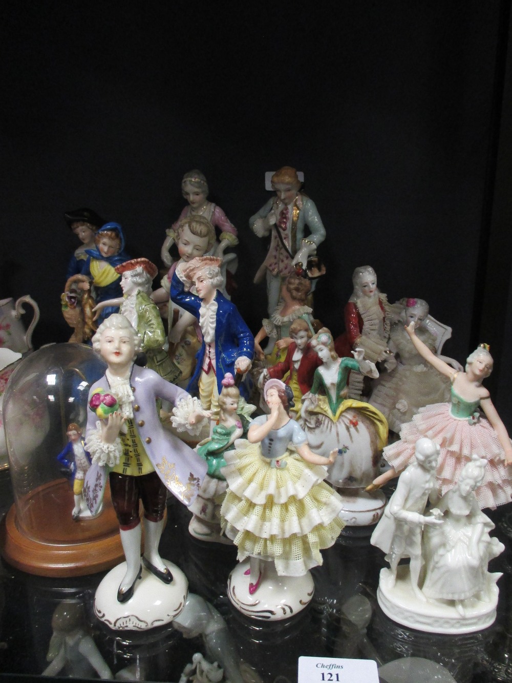 A quantity of porcelain figurines in 18th century dress