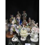A quantity of porcelain figurines in 18th century dress
