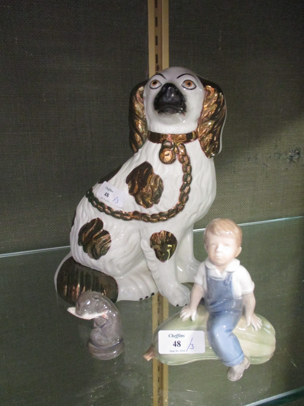 Two Copenhagen figures together with a Staffordshire spaniel