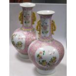 A pair of Chinese pink ground bottle vases, Guangxu marks, with wood stands See photos. Possible