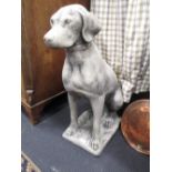 A pair of reconstituted stone figures of labradors or weimarners on a rectangular plinth base,