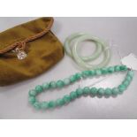 Two Chinese greenstone bangles, together with a bead necklace