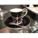 A cased set of Aynsley coffee cups and saucers with gilt cup holders Chip to the rim of one coffee