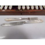 A cased set of 12 silver dessert knives and forks with mother of pearl handles