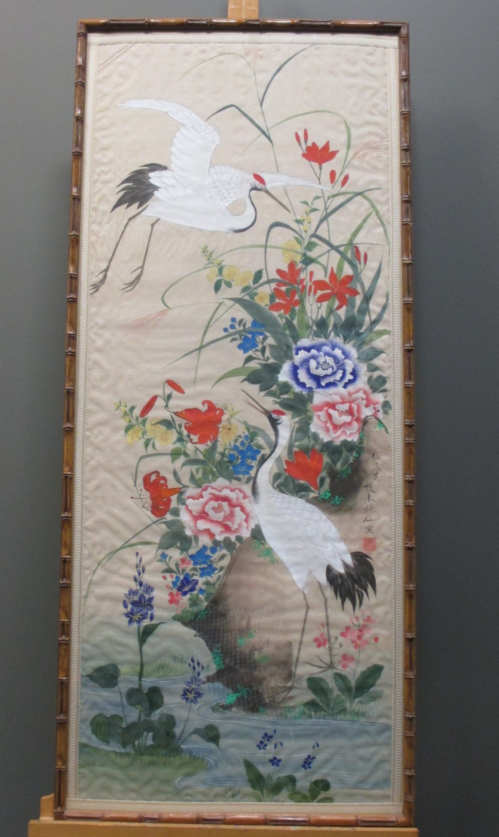 A Chinese painting on silk of cranes amongst foliage