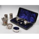 A cased pair of silver salts, two others, two peppers and a drum mustard