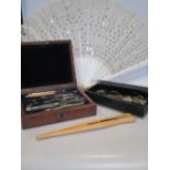 A set of drawing instruments, cased, a fan in original box, a pair of glove stretchers, opera