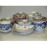 A collection of 18th century style Arita and Imari bowls some with covers (20)