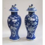 A pair of blue and white ginger jars with lion dog decorated covers - repairs (2) 32cm high