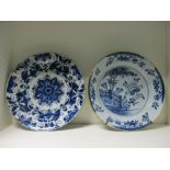 Two mid 18th century Delft blue and white dishes, 35.5cm (14 in) diameter (2) Both have glaze losses