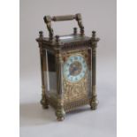 A mid Victorian brass cased carriage timepiece with arabic numerals and trellis decorated frame,