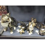 A collection of four tabby cat figures