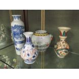 A Chinese blue and white vase painted with the gods of thunder, together with three other vases,