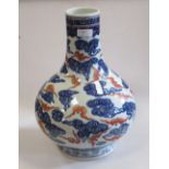 A Chinese bottle vase painted with iron red bats amongst blue clouds, 36cm high