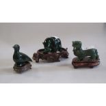 A carved green jade figure of a bear carrying a salmon, a duck and a lion dog (3)