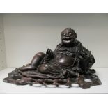 A 19th century hardwood figure of a Liu Hai and stand,