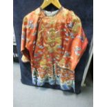 A child's orange silk dragon robe