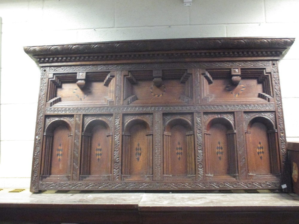 A 17th century carved overmantle in the Knowle style originally from the head of a four post bed