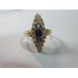 An Edwardian navette form sapphire and diamond ring, set in 18ct gold, with a vertical line of three