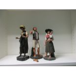 A pair of 19th century Portuguese painted terracotta singers and another of a lady, one base