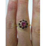 A ruby and red hardstone cluster ring, all set in yellow precious metal (marks worn, likely to