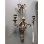 A pair of gilt metal cherub and ribbon sway two branch wall mounted candlesticks, 54cm long