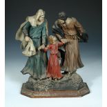 A carved wooden group of the Holy family, two praying nuns and a key board player, the group,