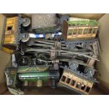 A group of O gauge tinplate trains, carriages and track