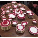 A Wedgwood part dinner service with red and gilt decorated border, comprising approximately one