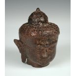 A bronze head of Buddha, probably Thai, with tightly curled hair and elongated ears 17cm (7in)