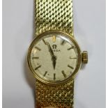 Omega - a lady's 18ct gold wristwatch, the white dial with gold coloured baton numerals, the 17
