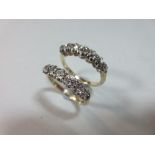 Two matched seven stone diamond rings, each with a graduated line of old round, cushion or mine